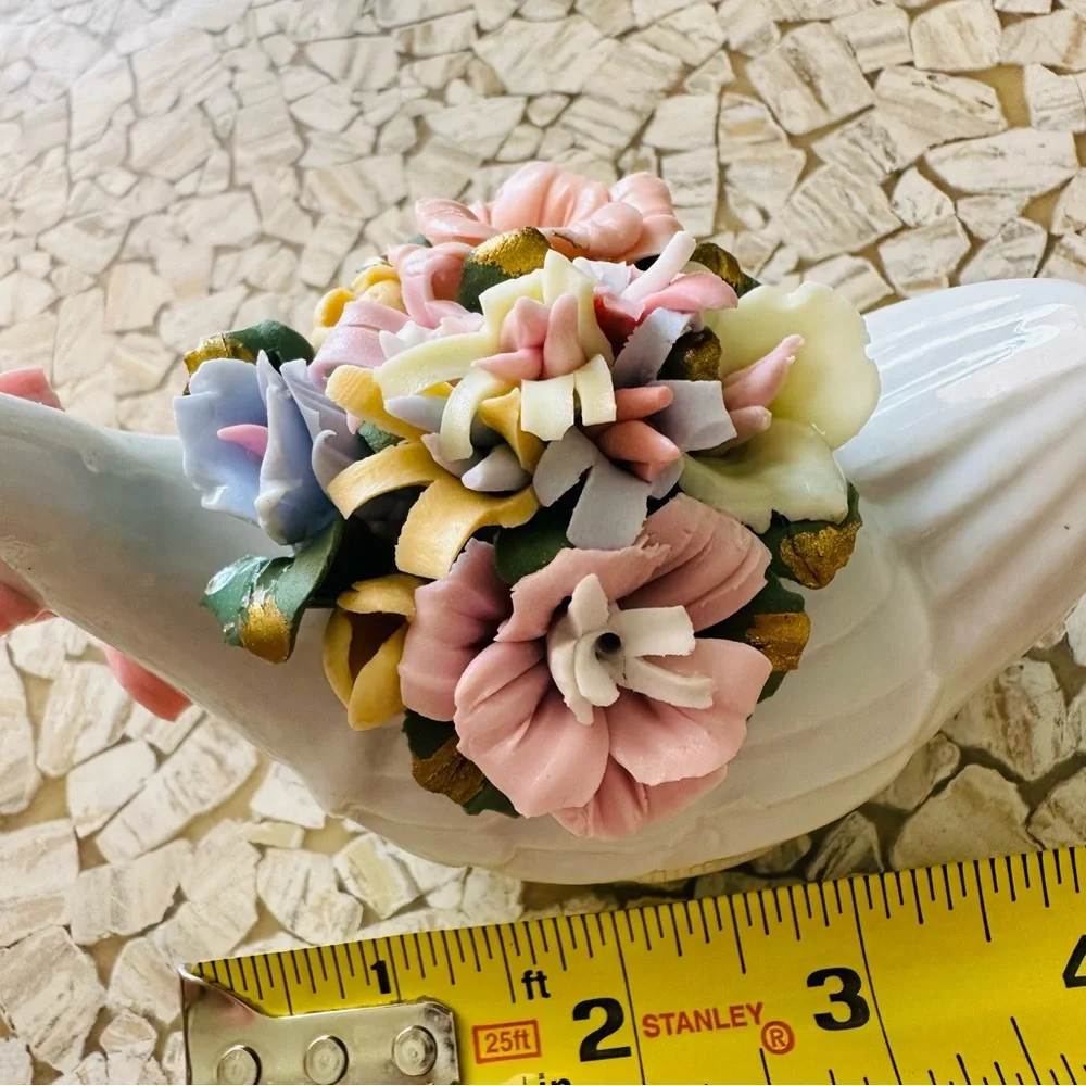 Beautiful little porcelain swan figurine with a back full of flowers!